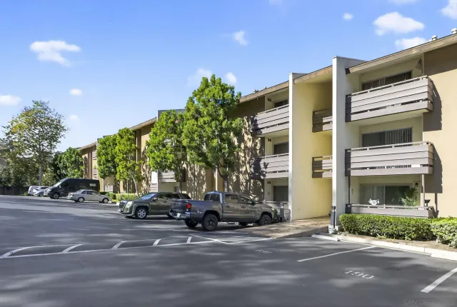 a view of a cars parked on the side of a street