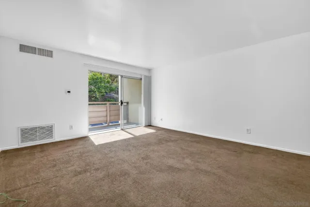 an empty room with an empty space and windows