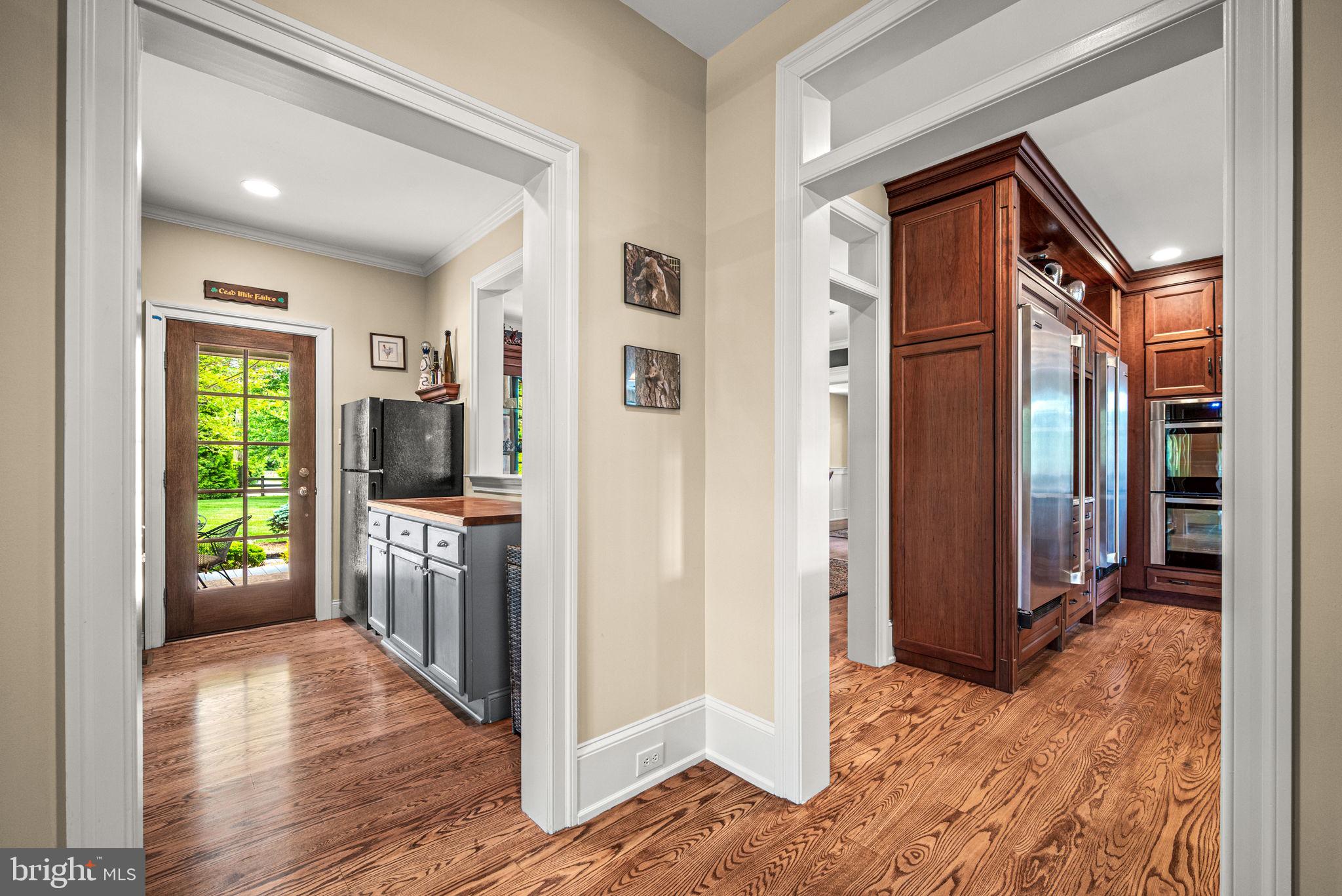 1548 Morstein Road Malvern, PA 19355 - Photo 28 of 80 a view of a hallway with wooden floor and a living room