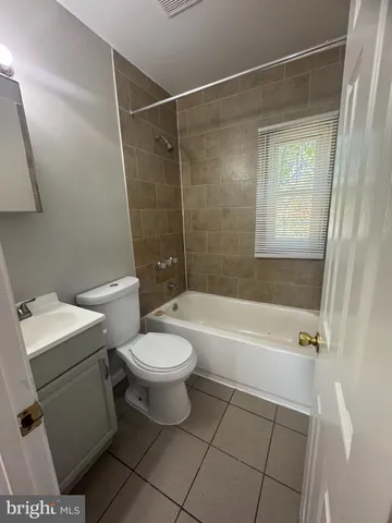 a bathroom with a toilet a sink and bathtub