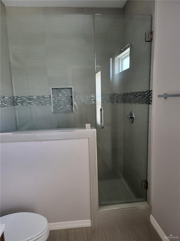 1900 Jackson Street, Unit 2 Weslaco, TX 78599 - Photo 10 of 13 a bathroom with a toilet and a shower