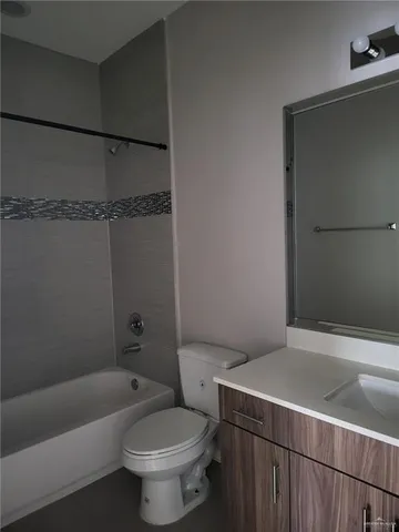 a bath room with a toilet and a bath tub
