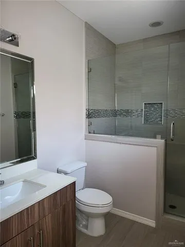 a bathroom with a sink a toilet and mirror