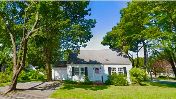 a front view of a house with a yard