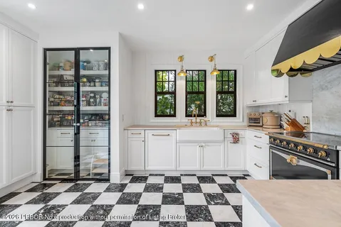 a kitchen with a checkered floor and white appliances