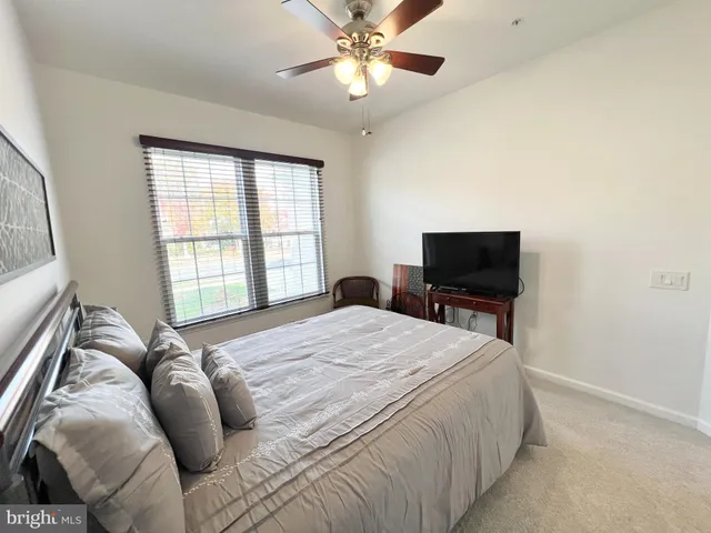 a bedroom with a bed and a television