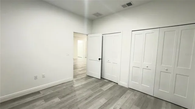 an empty room with wooden floor