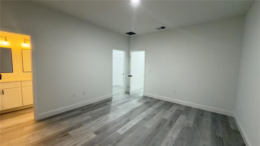 13047 Southwest 79th Circle Ocala, FL 34473 - Photo 21 of 29 wooden floor in an empty room with a window