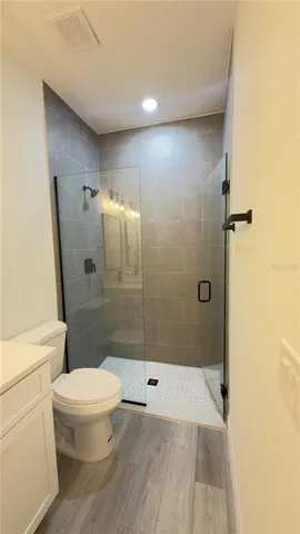 a bathroom with a shower and a toilet