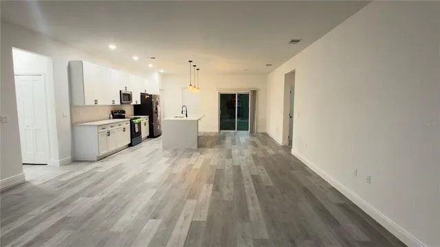 a view of a kitchen with a sink and microwave