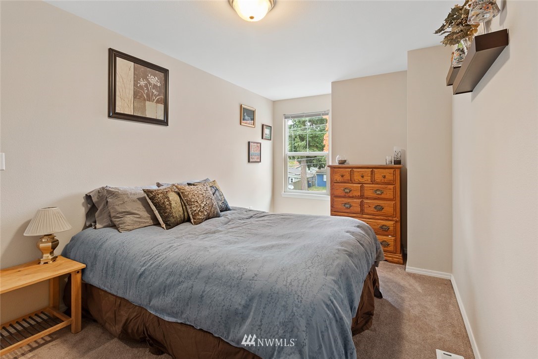 3711 Northeast 6th Street Renton, WA 98056 - Photo 11 of 20 a bed sitting in a bedroom next to a window with a dresser
