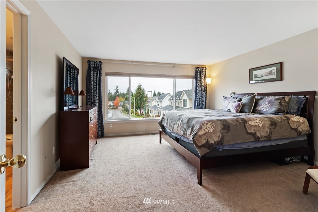 3711 Northeast 6th Street Renton, WA 98056 - Photo 15 of 20 a bedroom with a bed and a large window