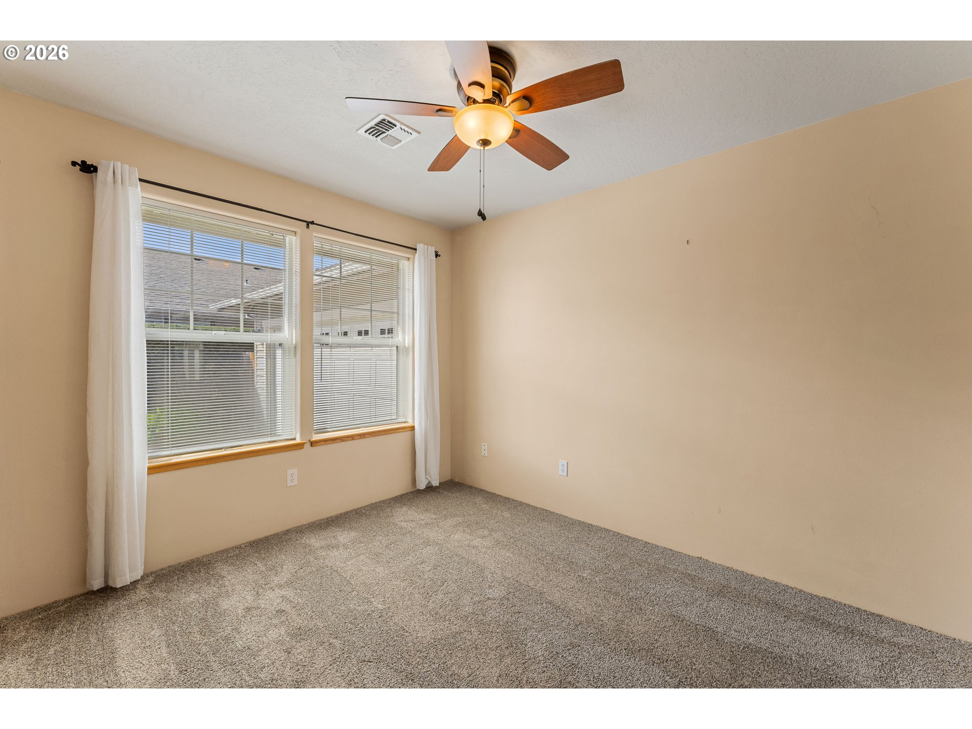 2188 Marie Drive Grants Pass, OR 97526 - Photo 19 of 27 an empty room with chandelier fan and windows