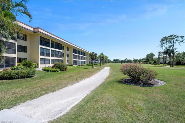 a view of a house with a yard and sitting area