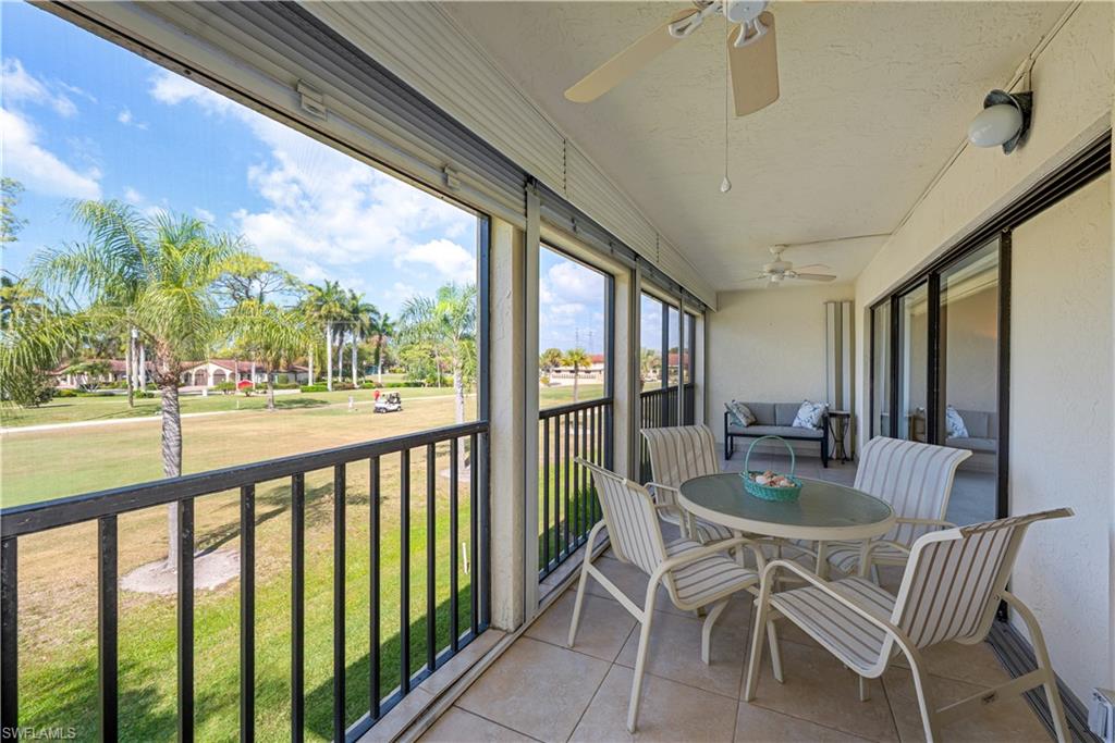 151 Quail Forest Boulevard, Unit 202 Naples, FL 34105 - Photo 3 of 15 Huge screened lanai with tile floors and storm shutters and outdoor dining area