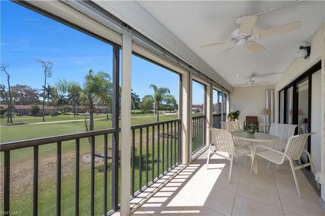 a view of a porch with furniture and backyard