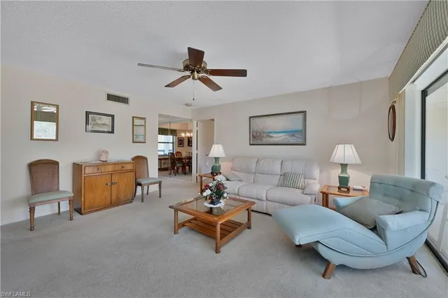 a living room with furniture and a night stand