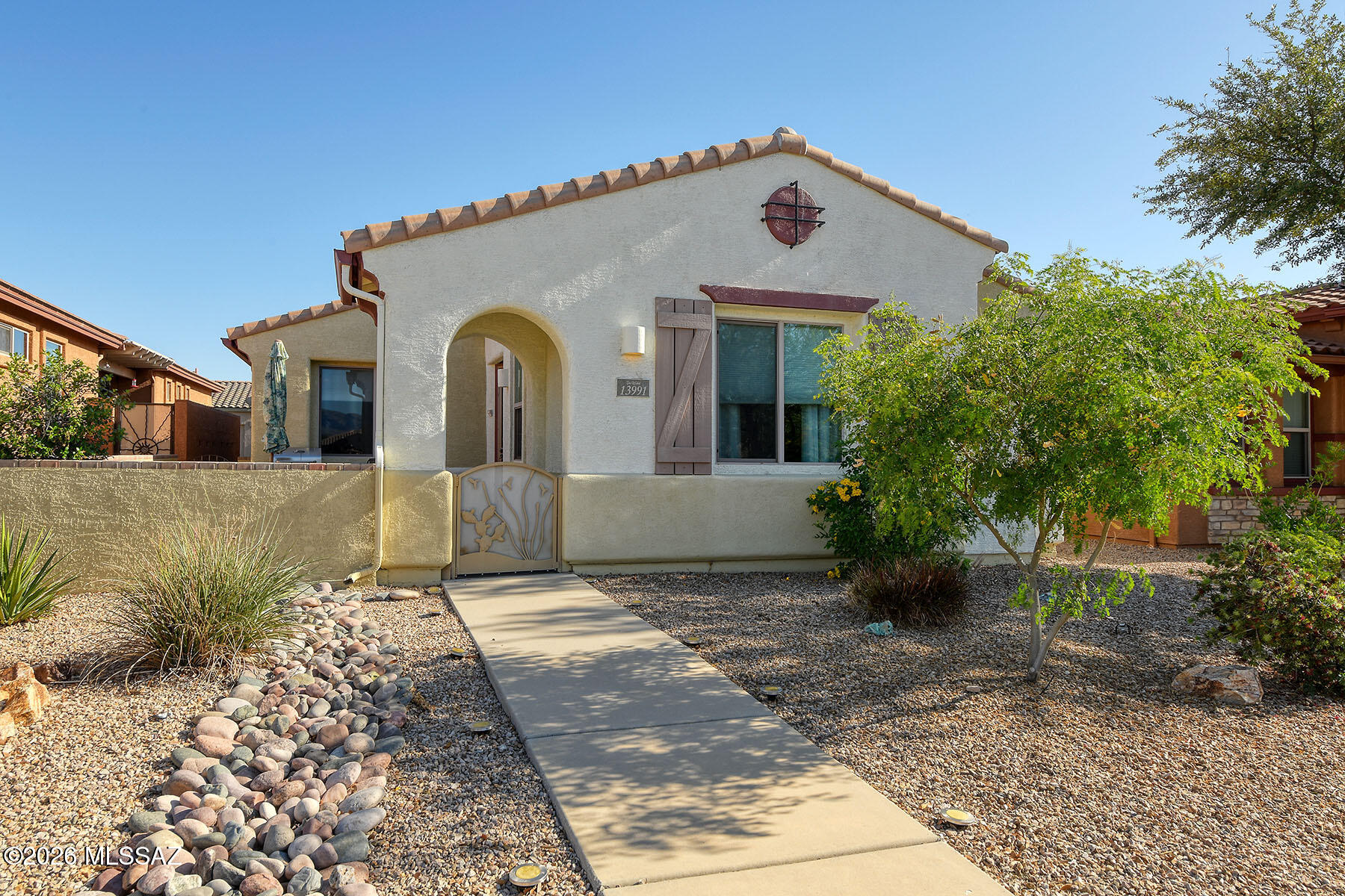 13991 East Cheavront Loop Vail, AZ 85641 - Photo 32 of 47 a front view of a house with a yard