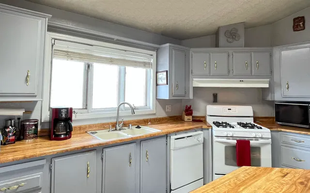 a kitchen with a sink stove and cabinets