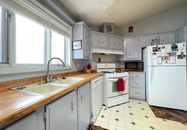 a kitchen with a sink stove and refrigerator