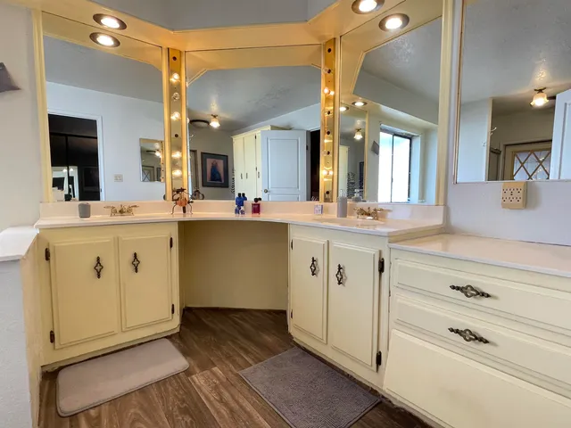 a view of a sink and dishwasher with wooden floor