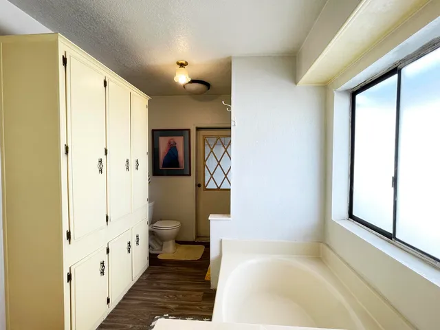 a spacious bathroom with a bathtub and a shower