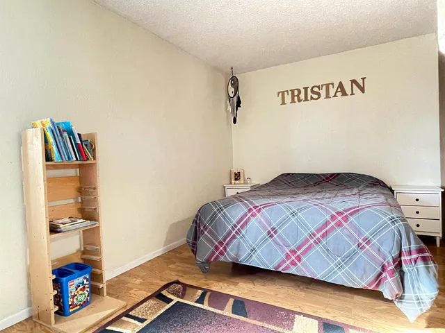 a bedroom with a bed and a book shelf