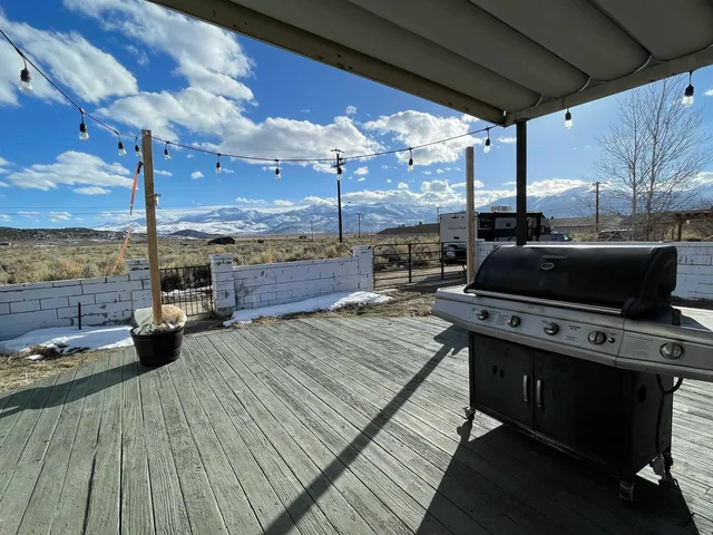 a view of a patio with table and chairs