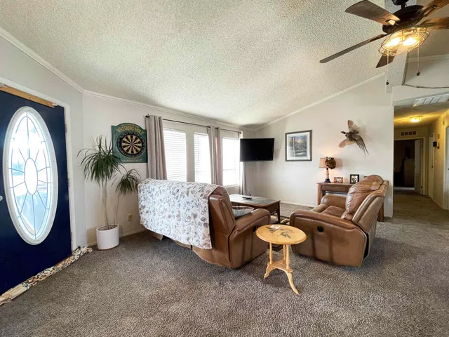 a living room with furniture a mirror and a window