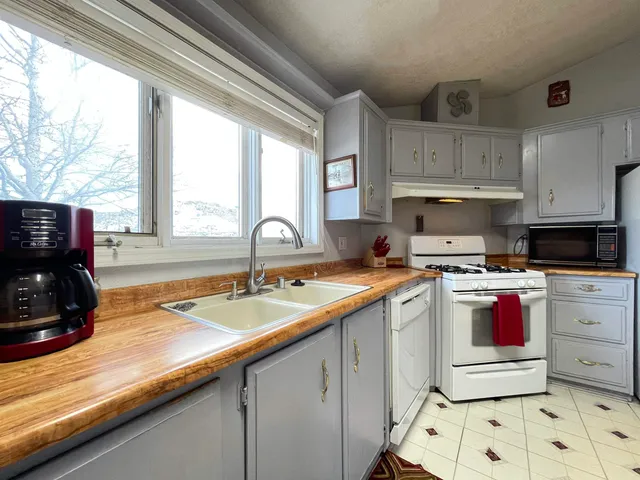 a kitchen with a sink stove and cabinets