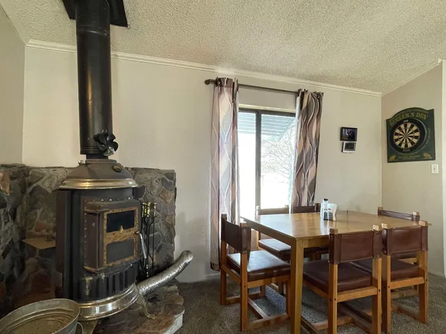 a view of a dining room with furniture and a window