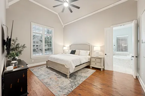 a bedroom with a large bed and a chandelier