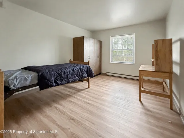 a living room with a bed furniture and a window