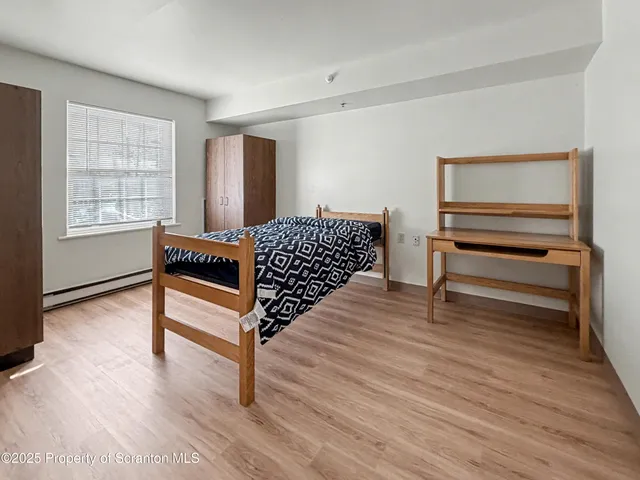 a bedroom with furniture and window