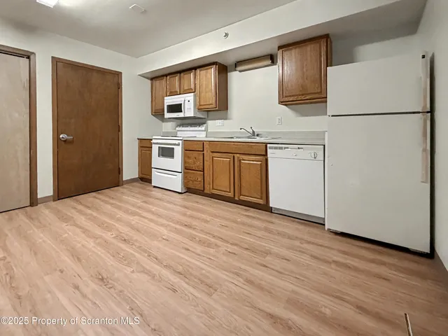 a kitchen with stainless steel appliances granite countertop a refrigerator sink and white stove