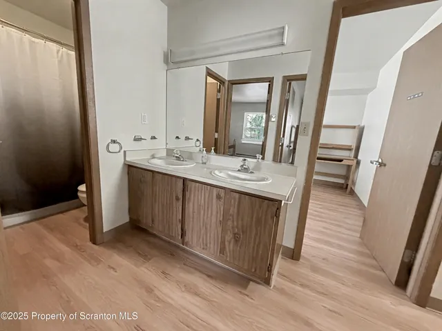 a bathroom with a double vanity sink and a mirror