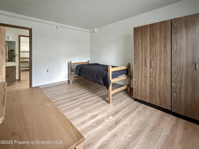 a spacious bedroom with a bed and a cabinets