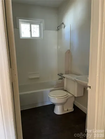 a bathroom with a toilet sink and shower