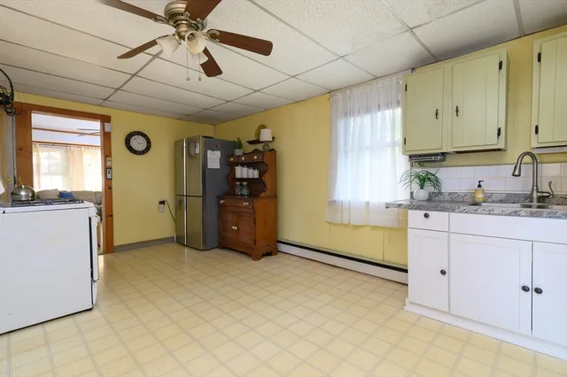 a kitchen with cabinets and window