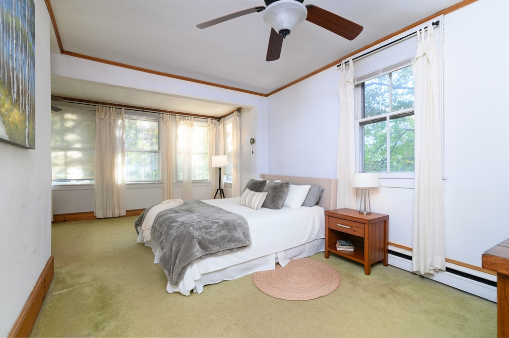 30 Puritan Road Weymouth, MA 02189 - Photo 19 of 34 a spacious bedroom with a bed and a chandelier