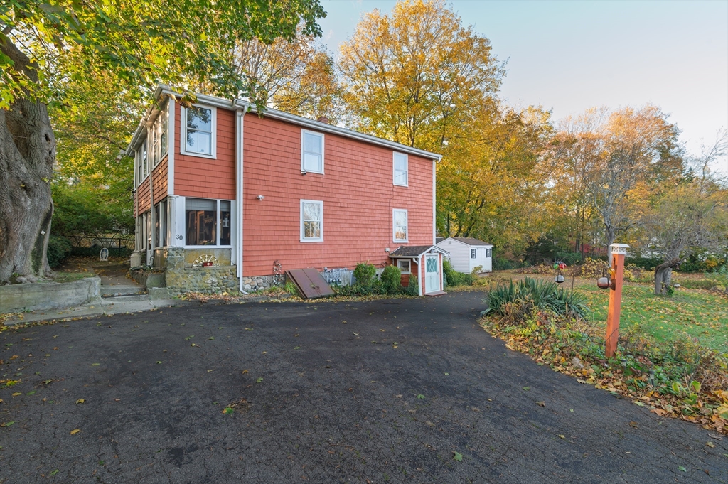 30 Puritan Road Weymouth, MA 02189 - Photo 2 of 34 a front view of a house with a yard and garage