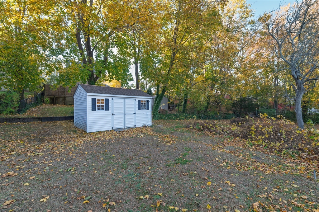 30 Puritan Road Weymouth, MA 02189 - Photo 24 of 34 a view of a house with a large tree and wooden fence