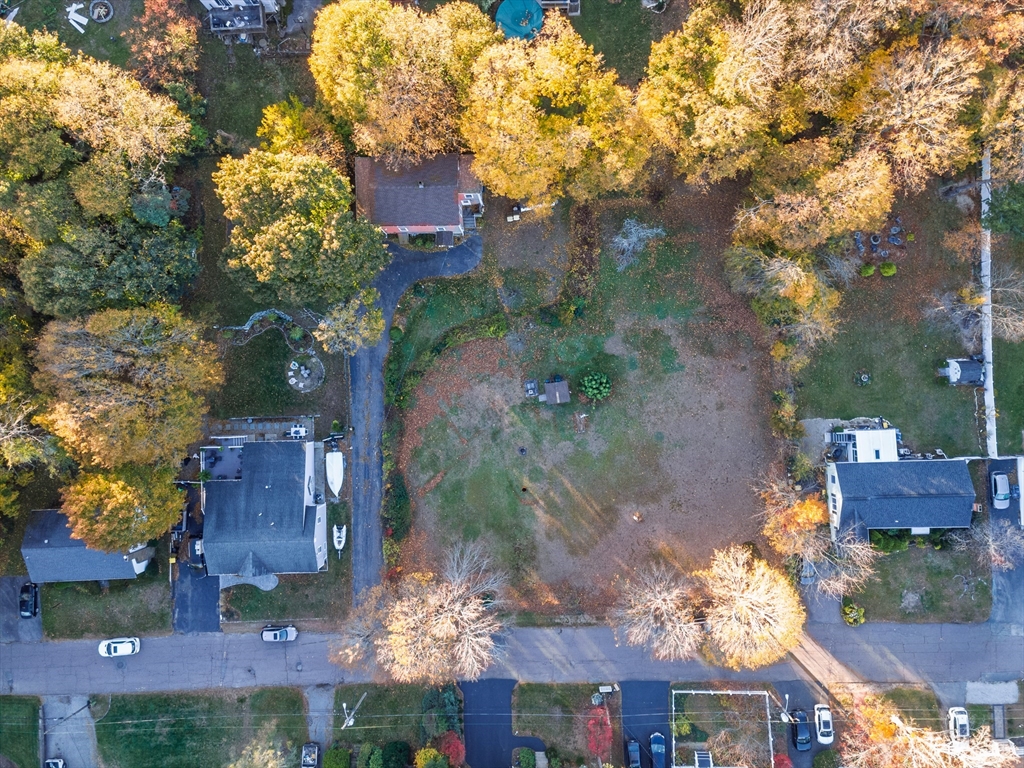 30 Puritan Road Weymouth, MA 02189 - Photo 28 of 34 an aerial view of a house with a yard and large trees