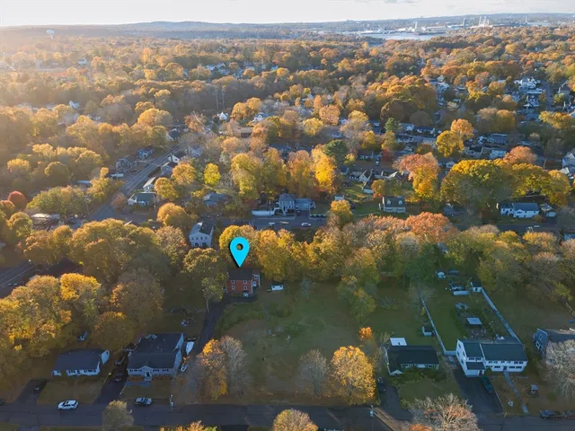 an aerial view of a house with a lake