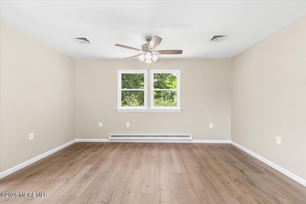 16 D Spring Street, Unit 50 Whiting, NJ 08759 - Photo 13 of 28 an empty room with wooden floor and windows