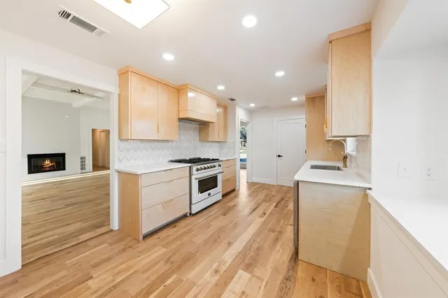 a kitchen with a stove a sink and a refrigerator