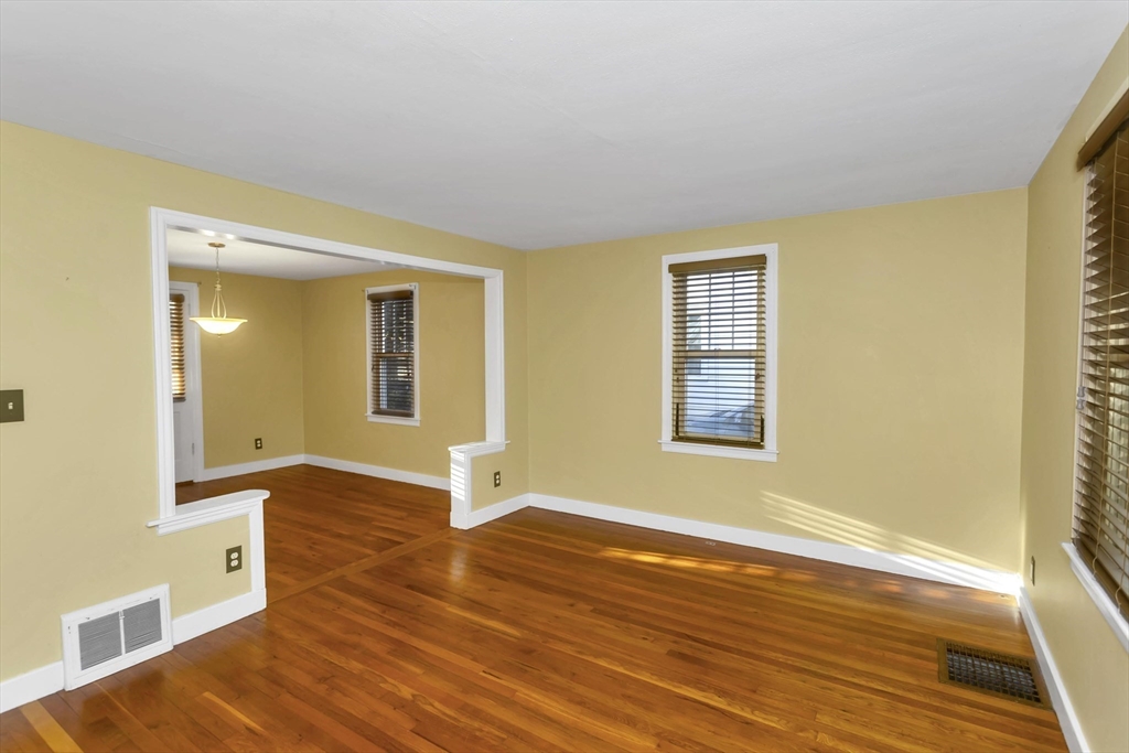 154 Ellsworth Avenue Springfield, MA 01118 - Photo 11 of 22 a view of an empty room with wooden floor and a window