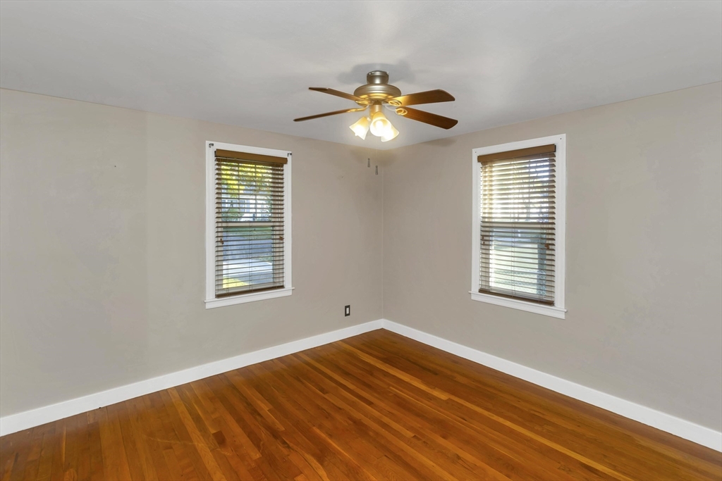 154 Ellsworth Avenue Springfield, MA 01118 - Photo 13 of 22 a view of an empty room with wooden floor and a window