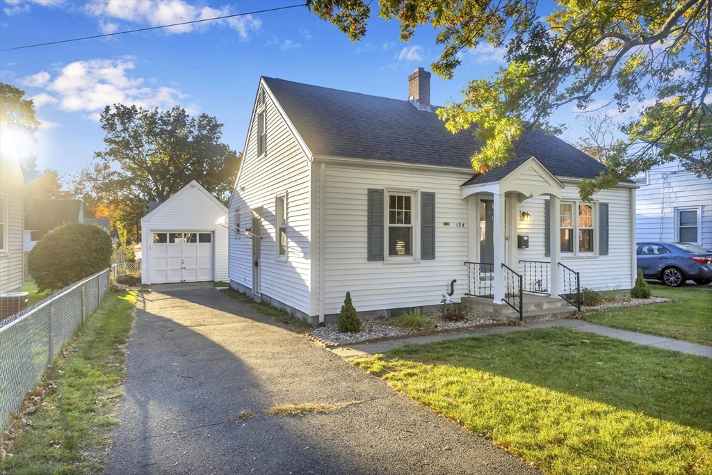 154 Ellsworth Avenue Springfield, MA 01118 - Photo 2 of 22 a front view of a house with a garden and yard