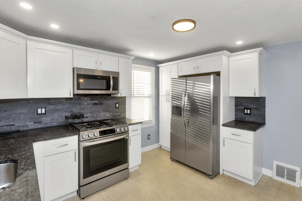 154 Ellsworth Avenue Springfield, MA 01118 - Photo 7 of 22 a kitchen with a stove and a microwave